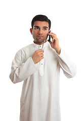 Image showing Thinking ethnic businessman on mobile phone