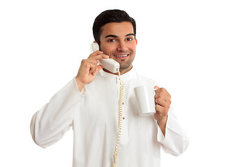 Image showing Friendly smiling ethnic businessman on telephone