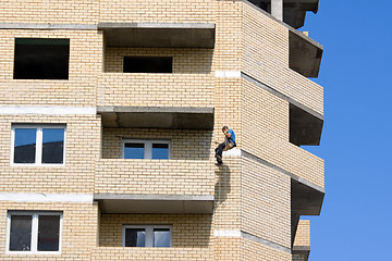 Image showing Worker painting house