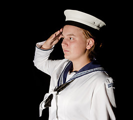 Image showing navy seaman saluting on black