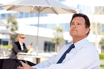 Image showing Handsome Businessman Looks Off Into the Distance