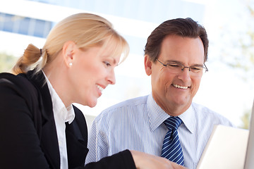 Image showing Businessman and Female Colleague Using Loptop Outdoors