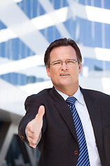 Image showing Businessman Outdoors Holds Out His Hand To Shake