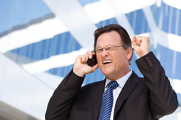 Image showing Excited Businessman on Cell Phone