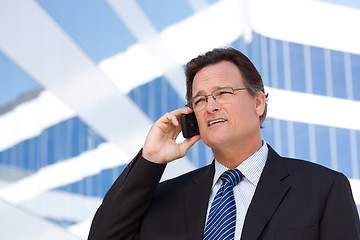 Image showing Businessman Smiles as He Talks on His Cell Phone