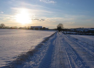 Image showing Sunset over a snowy road