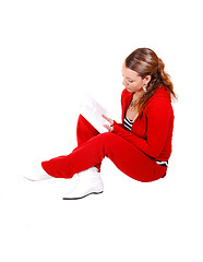 Image showing Girl sitting on floor and reading. 