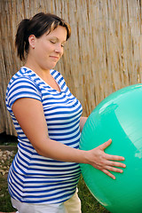 Image showing Pregnant young woman exercising with ball