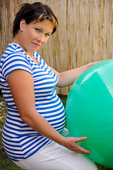 Image showing Pregnant young woman exercising with ball