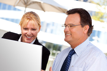 Image showing Businessman and Female Colleague Using Loptop Outdoors