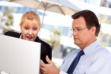 Image showing Businessman and Female Colleague Using Loptop Outdoors