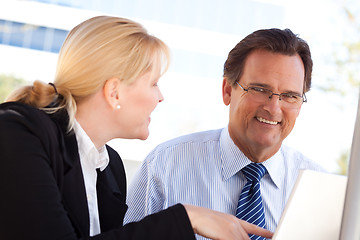 Image showing Businessman and Female Colleague Using Loptop Outdoors