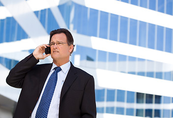 Image showing Concerned Businessman Talks on His Cell Phone