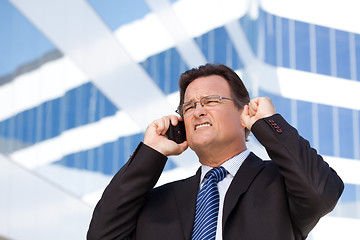 Image showing Excited Businessman on Cell Phone