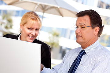 Image showing Businessman and Female Colleague Using Loptop Outdoors