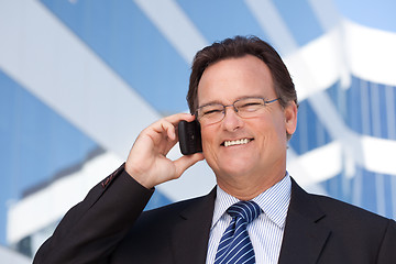 Image showing Businessman Smiles as He Talks on His Cell Phone