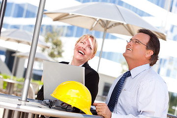 Image showing Businesswoman and Man Laughing While Working