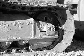 Image showing bulldozer front wheel in black and white