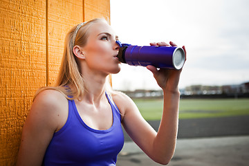 Image showing Sporty woman drinking