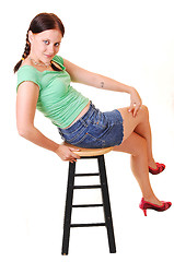 Image showing Pretty girl sitting on bar chair.