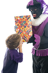 Image showing Zwarte Piet giving a child his present