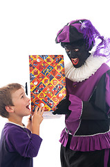 Image showing Zwarte Piet giving a child his present