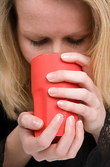 Image showing Woman holding a cup of coffee