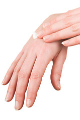 Image showing Woman putting cream on her hands