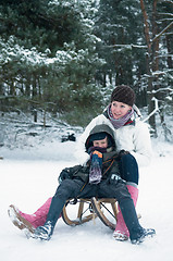 Image showing Boy and girl on a sled