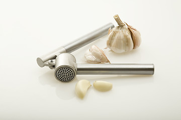 Image showing Garlic and a garlic press