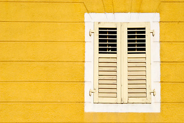 Image showing Yellow wall an and wooden window