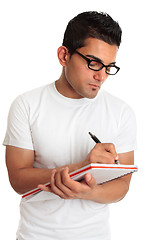 Image showing Student or man wearing glasses writing