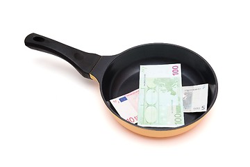 Image showing Black frying pan with euro bills isolated