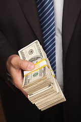 Image showing Businessman Handing Over Stack of Cash