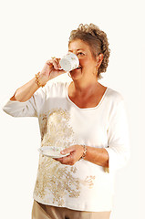 Image showing Senior woman tingling coffee.