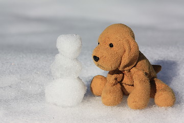 Image showing Dog making a snowman