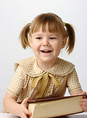 Image showing Happy little girl with book, back to school