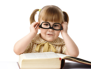 Image showing Happy little girl with books wearing black glasses