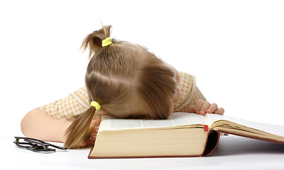 Image showing Little girl is sleeping on book, back to school
