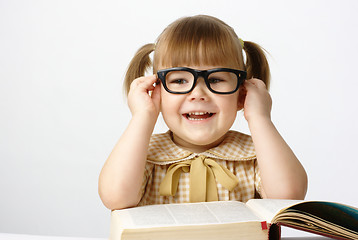 Image showing Happy little girl with books wearing black glasses