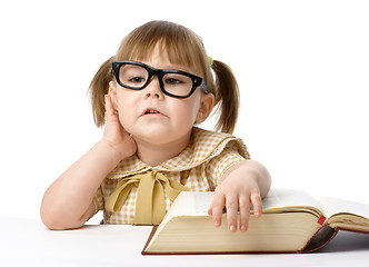 Image showing Happy little girl with book, back to school