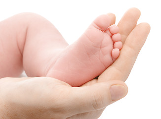 Image showing Mother holding her newborn's foot