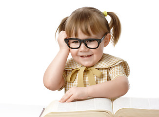 Image showing Happy little girl with books wearing black glasses