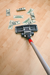 Image showing Vacuum cleaner and money