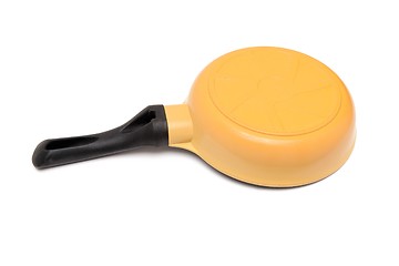 Image showing Black and yellow frying pan upside down isolated 