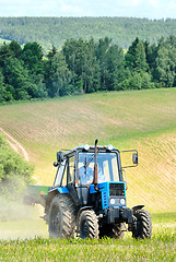 Image showing Tractor in a field in early summer