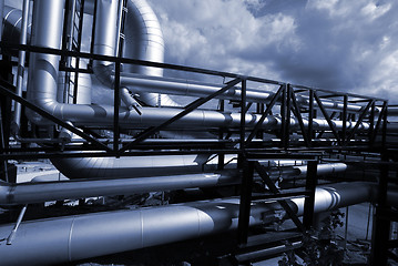 Image showing Pipes, bolts, valves against blue sky in blue tones