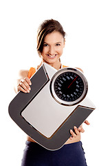 Image showing Athletic girl with a scale