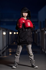 Image showing Young intense asian boy wearing boxing gloves