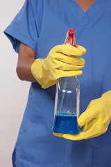 Image showing Asian woman nurse holding cleaning solution